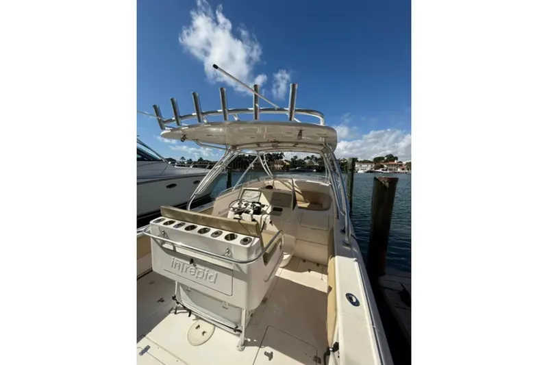 Slide: The Image of 2008 Intrepid 370 Cuddy boat docked under clear blue sky. - 20