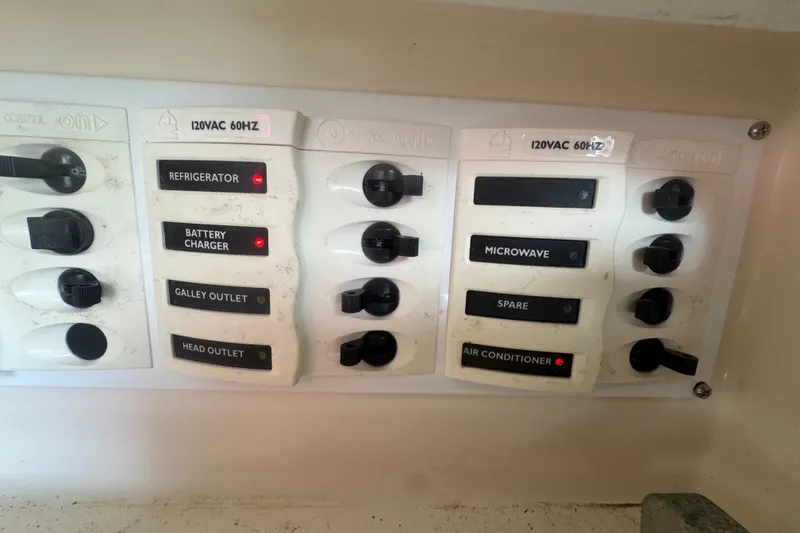 Slide: The Image of Electrical panel of a 2008 Intrepid 370 Cuddy boat with labeled switches. - 59