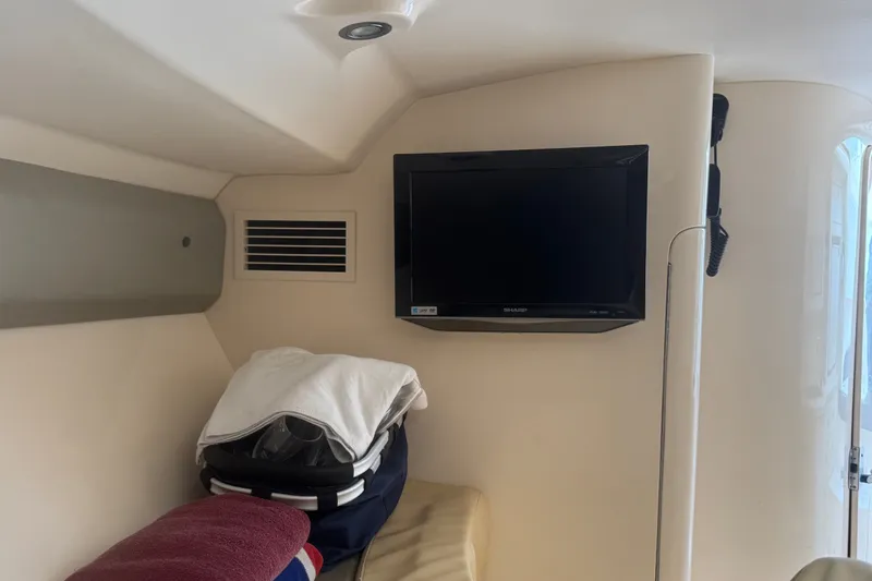 Slide: The Image of Interior of a 2008 Intrepid 370 Cuddy with TV and storage area. - 45