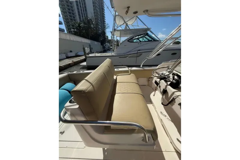 Slide: The Image of 2008 Intrepid 370 Cuddy boat interior with beige seating and steering console. - 24