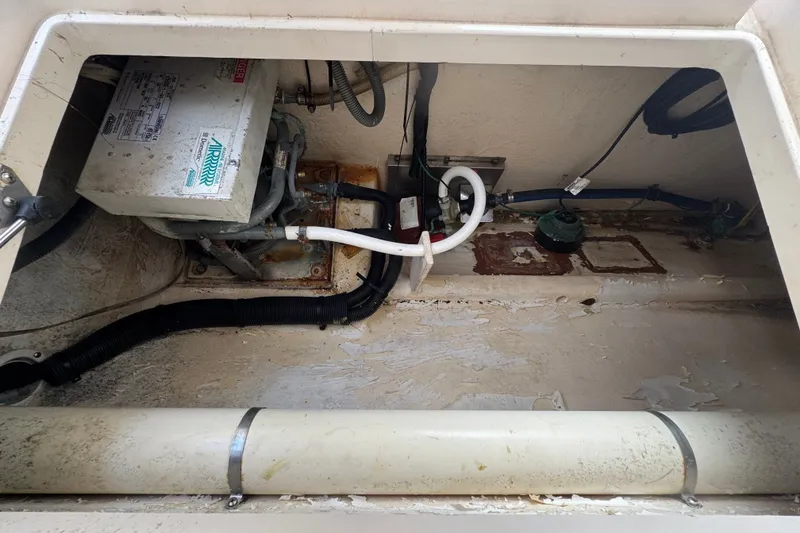 Slide: The Image of 2008 Intrepid 370 Cuddy engine compartment with visible wiring and equipment. - 22