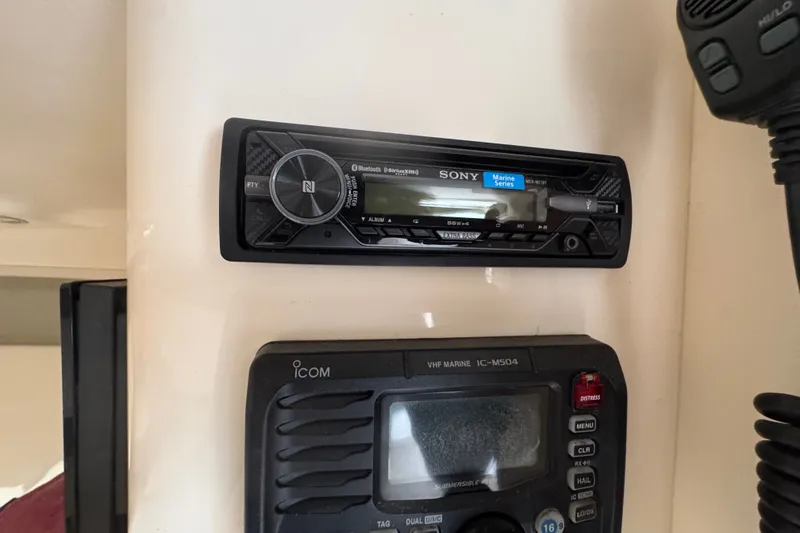 Slide: The Image of Sony marine stereo and Icom VHF radio on 2008 Intrepid 370 Cuddy boat. - 53