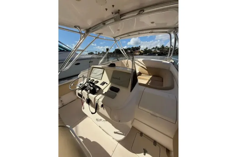 Slide: The Image of 2008 Intrepid 370 Cuddy boat interior with steering console and seating area. - 25