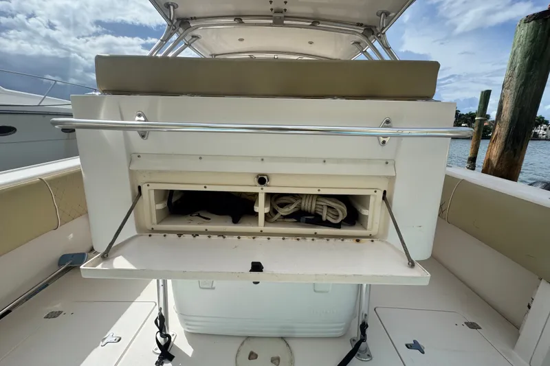 Slide: The Image of 2008 Intrepid 370 Cuddy boat storage compartment with open hatch, dockside view. - 19