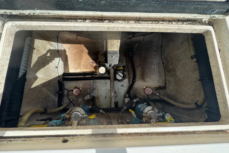 Slide: The Image of 2008 Intrepid 370 Cuddy engine compartment with visible hoses and mechanical components. - 13