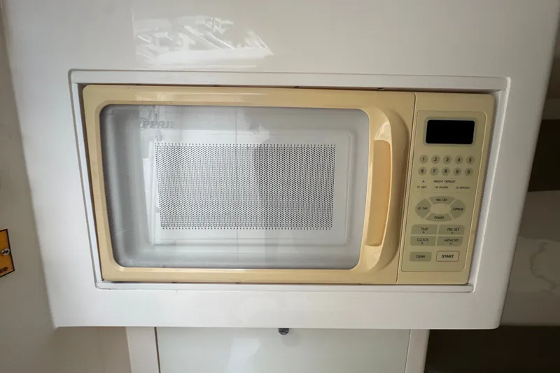 Slide: The Image of Built-in microwave in a 2008 Intrepid 370 Cuddy boat kitchen. - 55