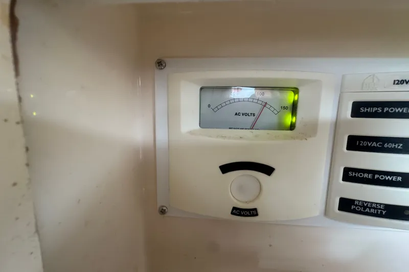 Slide: The Image of AC voltage meter on 2008 Intrepid 370 Cuddy boat, displaying voltage levels and power controls. - 62