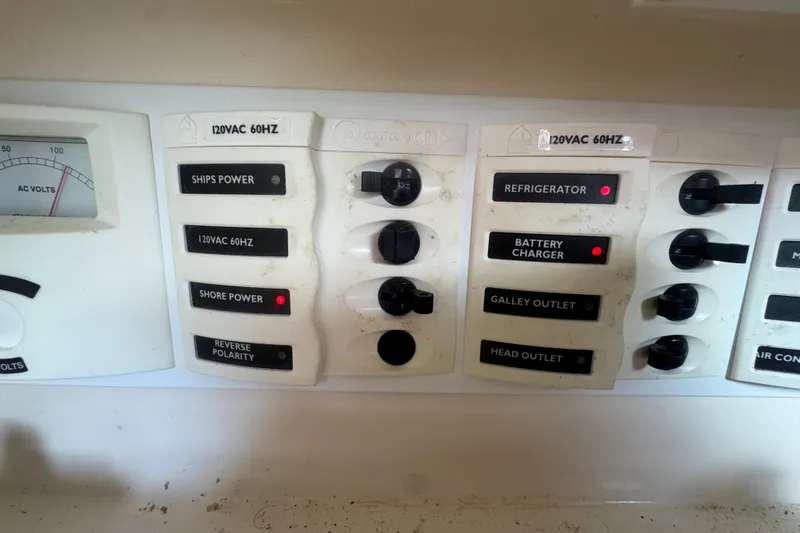 Slide: The Image of Electrical panel of a 2008 Intrepid 370 Cuddy boat with labeled switches and indicators. - 60