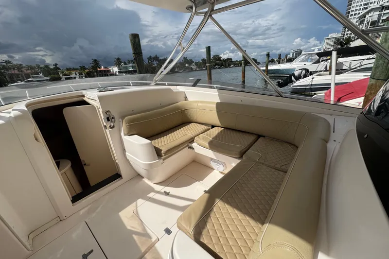 Slide: The Image of 2008 Intrepid 370 Cuddy boat interior with beige seating and open cabin door. - 35
