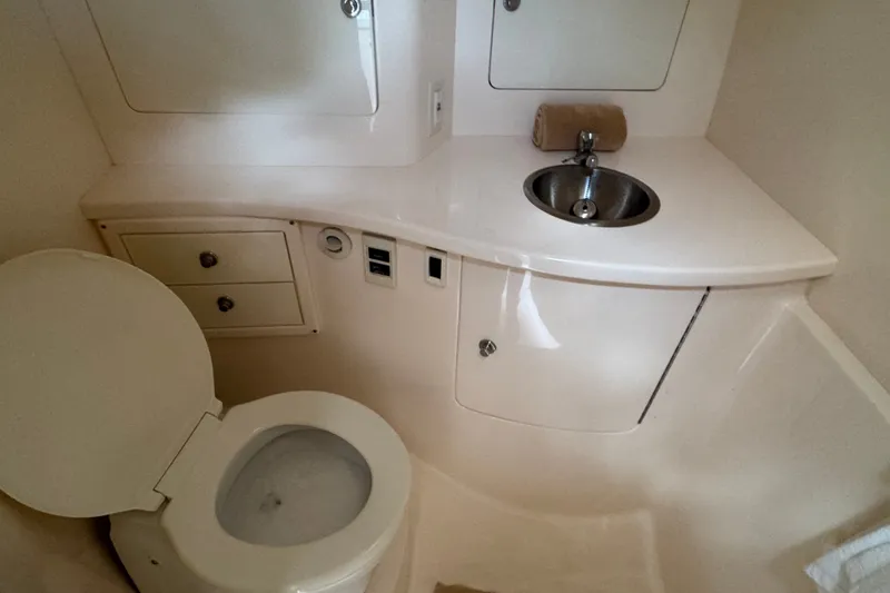 Slide: The Image of Compact bathroom in 2008 Intrepid 370 Cuddy boat with toilet and sink. - 50