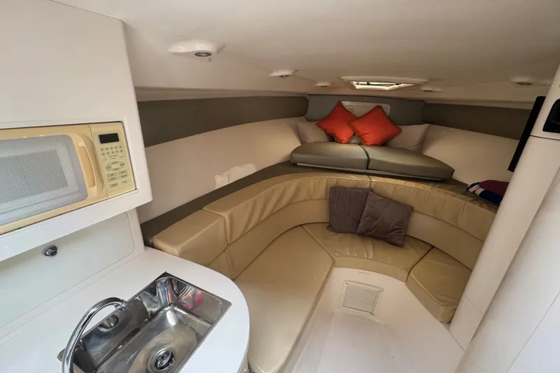 Slide: The Image of 2008 Intrepid 370 Cuddy cabin interior with seating, sink, and microwave. - 42