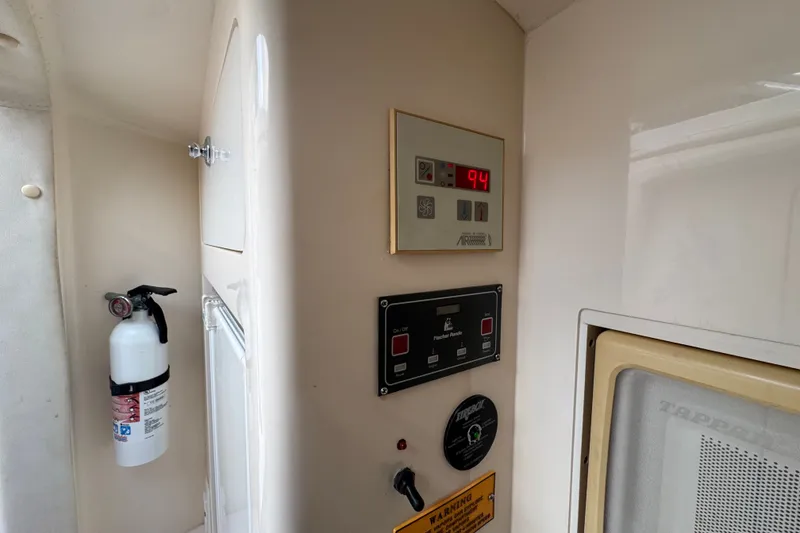 Slide: The Image of Control panel and fire extinguisher inside 2008 Intrepid 370 Cuddy boat cabin. - 57