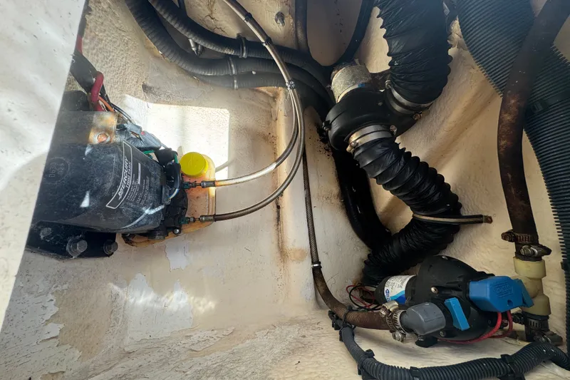 Slide: The Image of Engine compartment of a 2008 Intrepid 370 Cuddy boat, showing mechanical components and hoses. - 17