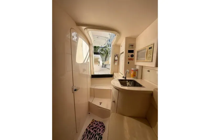 Slide: The Image of Interior of 2008 Intrepid 370 Cuddy boat, featuring kitchenette and seating area. - 47