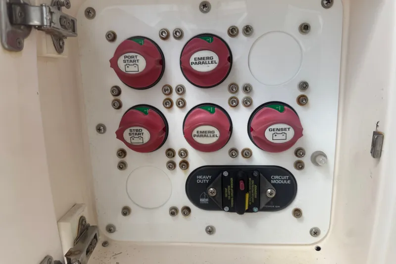 Slide: The Image of Control panel of a 2008 Intrepid 370 Cuddy boat with labeled switches and circuit module. - 63