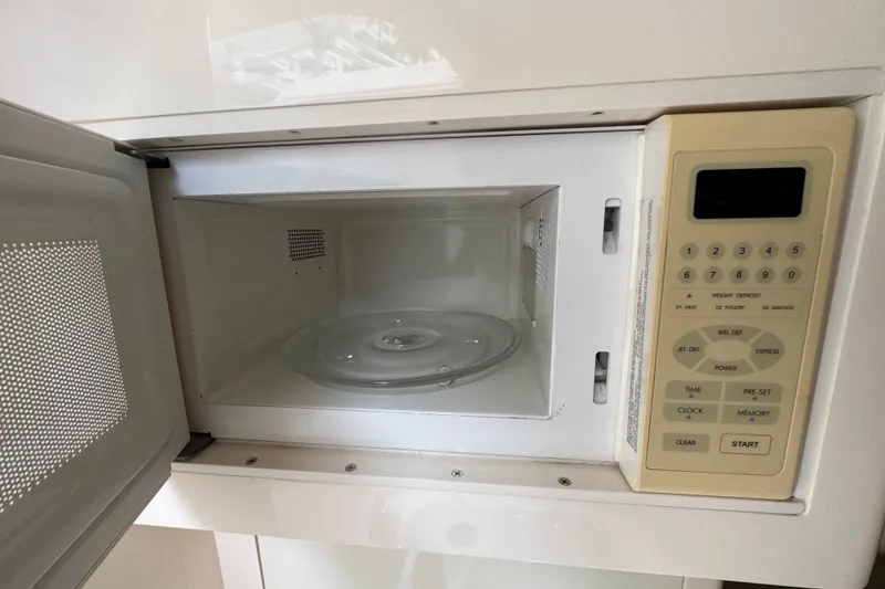 Slide: The Image of Open microwave oven with digital keypad in a 2008 Intrepid 370 Cuddy boat. - 56