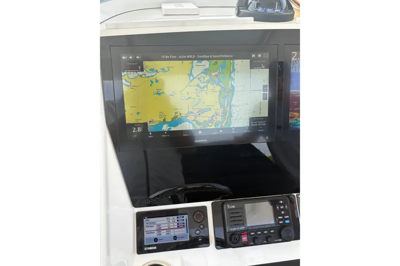 Slide: The Image of 2015 Regulator 25 boat dashboard with Garmin navigation display and Yamaha controls. - 16