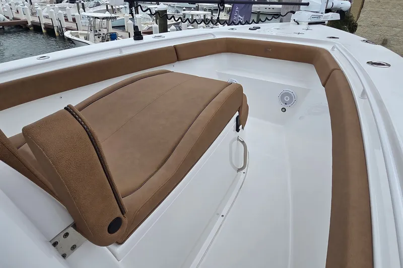 Slide: The Image of 2021 Sea Hunt Gamefish 27CB boat interior with tan seating and white deck. - 27