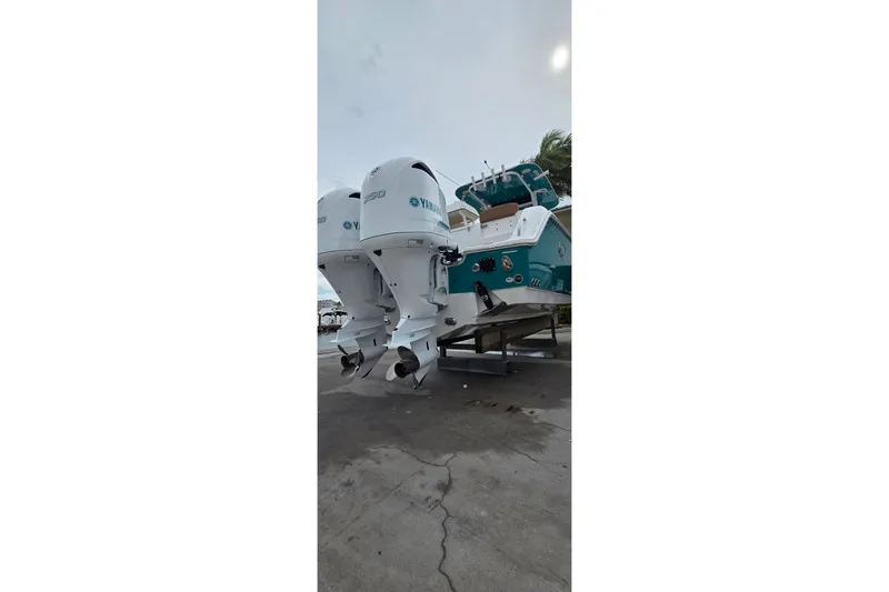 Slide: The Image of 2021 Sea Hunt Gamefish 27CB boat with dual Yamaha outboard engines. - 30