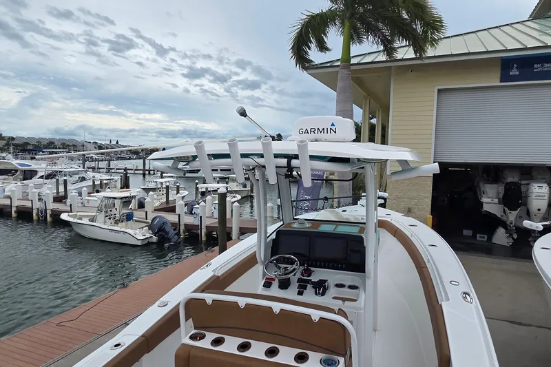 Slide: The Image of 2021 Sea Hunt Gamefish 27CB docked at marina, featuring Garmin navigation system. - 34
