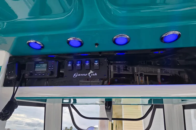 Slide: The Image of 2021 Sea Hunt Gamefish 27CB dashboard with blue LED lights and Garmin electronics. - 21
