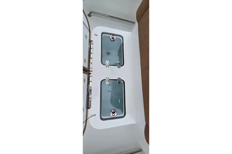 Slide: The Image of 2021 Sea Hunt Gamefish 27CB boat storage compartments with secure latches. - 26