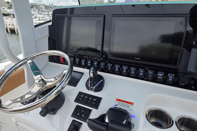 Slide: The Image of 2021 Sea Hunt Gamefish 27CB helm with dual Garmin displays and stainless steel steering wheel. - 19
