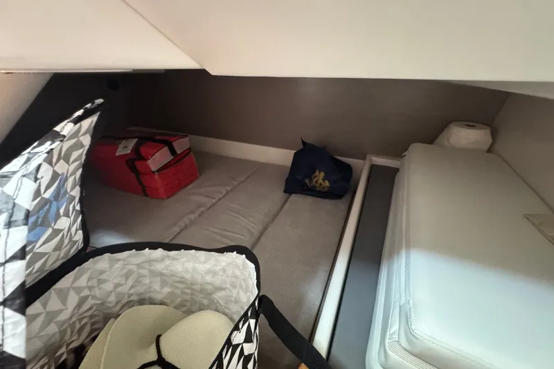 Slide: The Image of Interior cabin of 2022 Tiara Yachts 43 LS with storage and cushions. - 23
