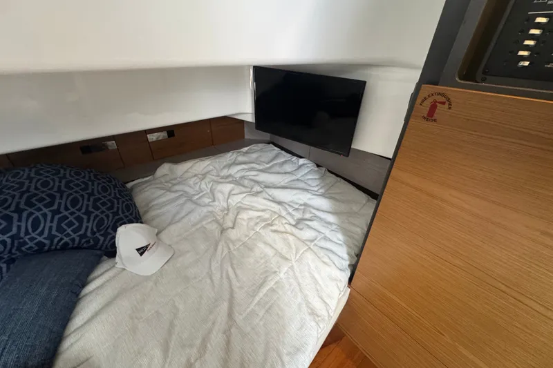Slide: The Image of Cozy cabin interior of 2022 Tiara Yachts 43 LS with bed, TV, and storage. - 21