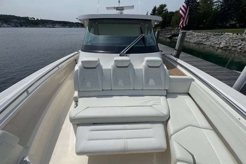 Slide: The Image of 2022 Tiara Yachts 43 LS luxury boat with spacious white seating and sleek design. - 12