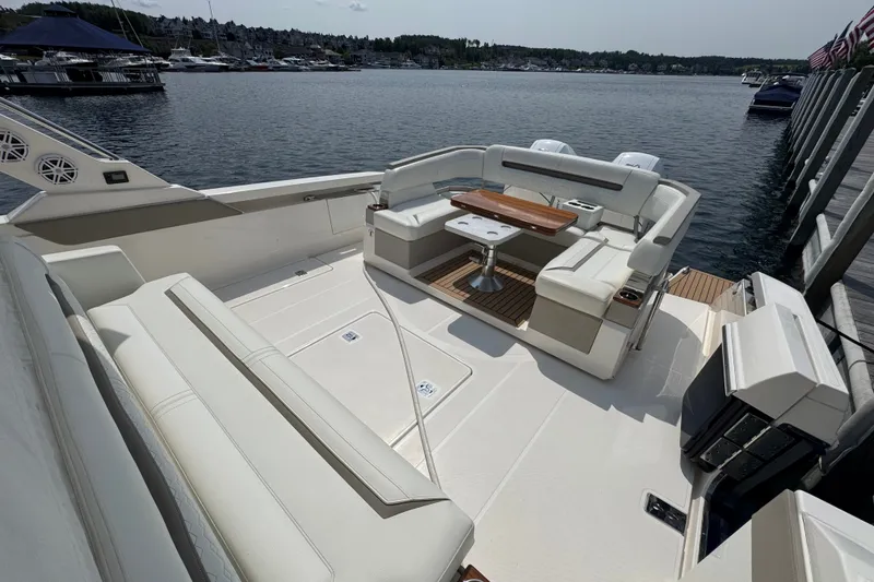 Slide: The Image of Luxurious 2022 Tiara Yachts 43 LS with elegant seating and scenic marina backdrop. - 5