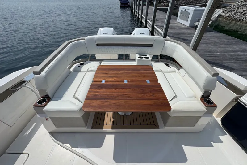 Slide: The Image of Luxurious seating area on 2022 Tiara Yachts 43 LS, featuring elegant wooden table. - 3