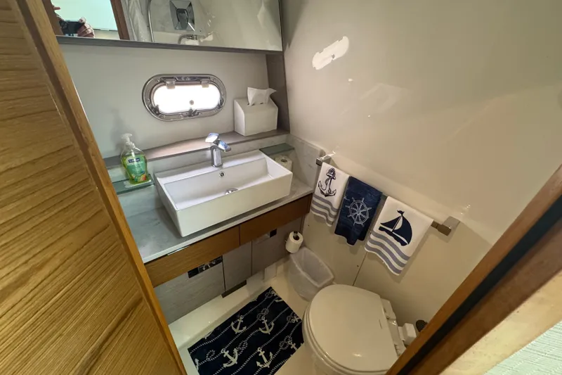 Slide: The Image of 2022 Tiara Yachts 43 LS bathroom with nautical-themed decor and modern fixtures. - 20