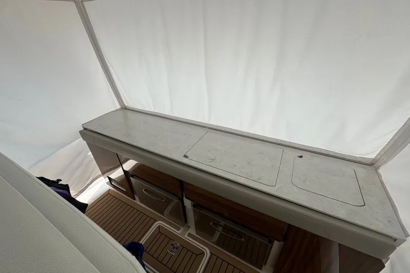 Slide: The Image of Interior view of 2022 Tiara Yachts 43 LS, featuring sleek countertops and wooden flooring. - 17