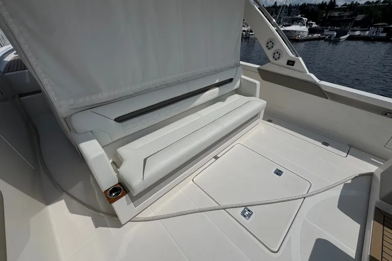Slide: The Image of 2022 Tiara Yachts 43 LS interior with white seating and deck, docked at marina. - 4