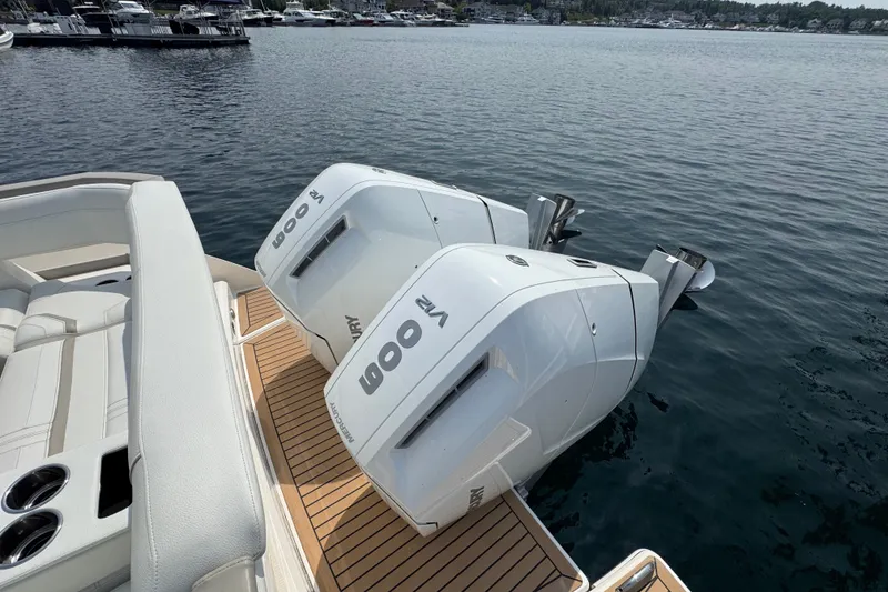 Slide: The Image of 2022 Tiara Yachts 43 LS with twin Mercury 600 engines on a serene lake. - 6