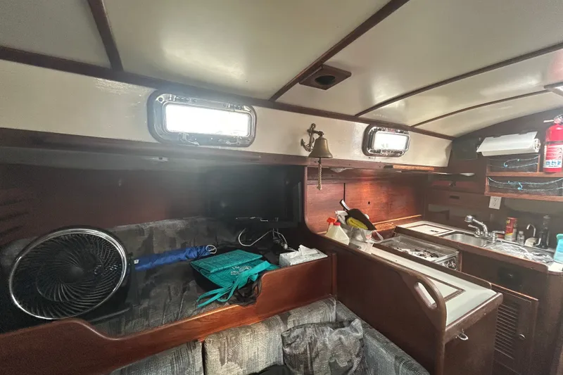 Slide: The Image of Interior of a 1979 Tartan 37 sailboat featuring a cozy galley and seating area. - 28