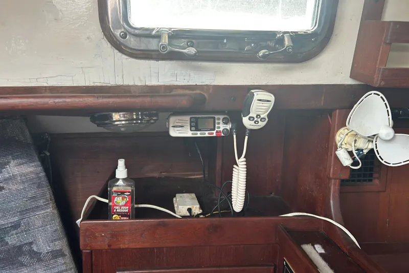 Slide: The Image of Interior of a 1979 Tartan 37 sailboat with radio, fan, and fuel odor remover. - 21