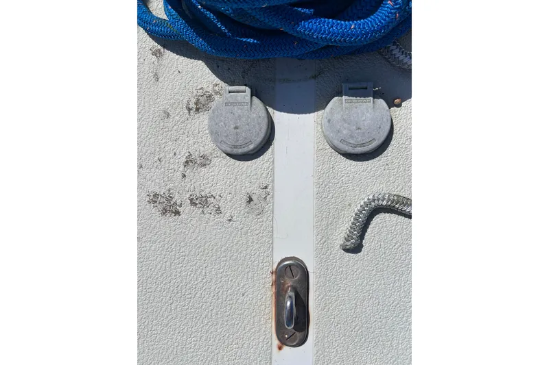 Slide: The Image of 1979 Tartan 37 deck with blue rope and metal fittings. - 62
