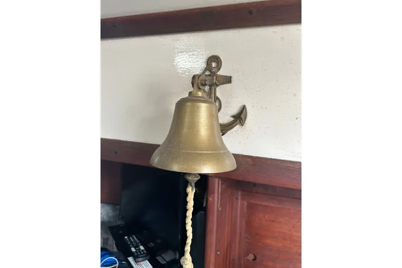Slide: The Image of Brass bell with anchor mount inside a 1979 Tartan 37 sailboat cabin. - 44