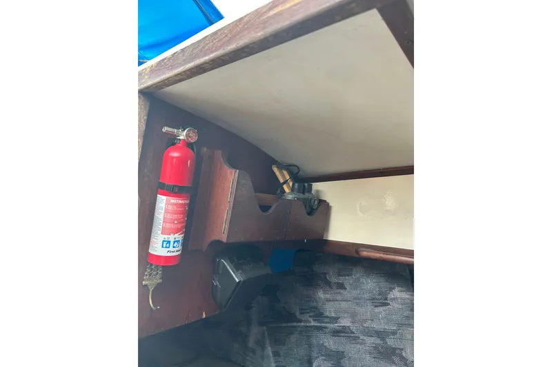 Slide: The Image of Interior of a 1979 Tartan 37 sailboat featuring a mounted fire extinguisher and storage compartments. - 45