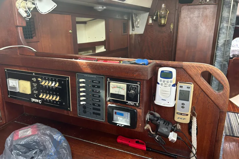Slide: The Image of Control panel of a 1979 Tartan 37 sailboat with various switches and devices. - 22