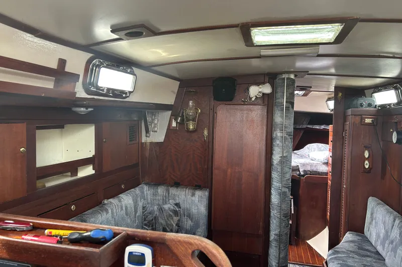 Slide: The Image of Interior of a 1979 Tartan 37 sailboat with wood paneling and cozy seating. - 23