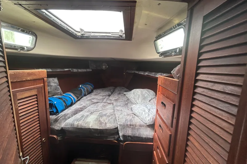 Slide: The Image of Interior cabin of a 1979 Tartan 37 sailboat with cozy bedding and wooden storage. - 31