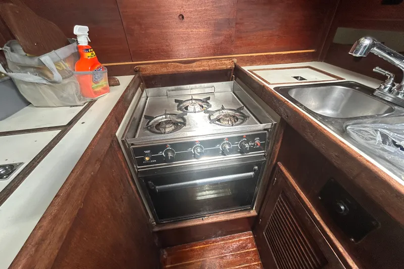 Slide: The Image of Compact kitchen area in a 1979 Tartan 37 sailboat with stove and sink. - 33