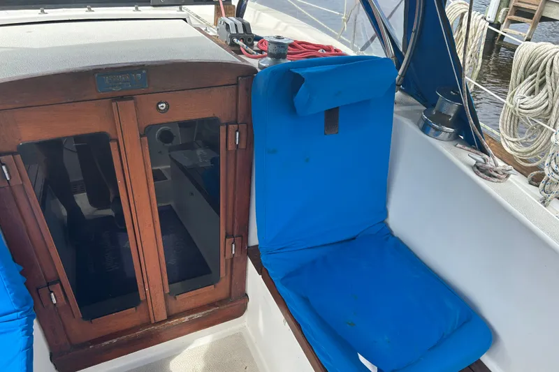 Slide: The Image of Cockpit of 1979 Tartan 37 sailboat with blue cushions and wooden hatch. - 17