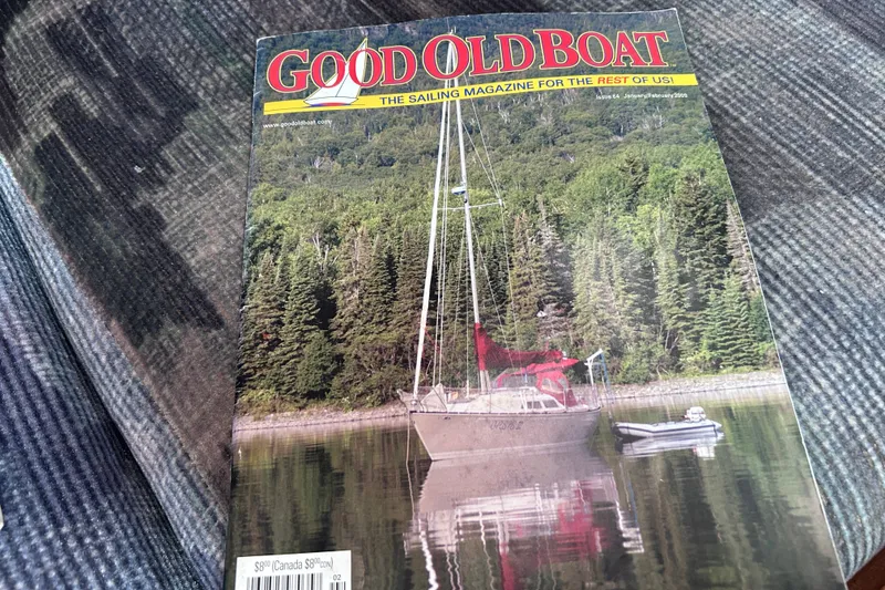 Slide: The Image of Good Old Boat magazine cover featuring a Tartan 37 sailboat on a serene lake. - 50