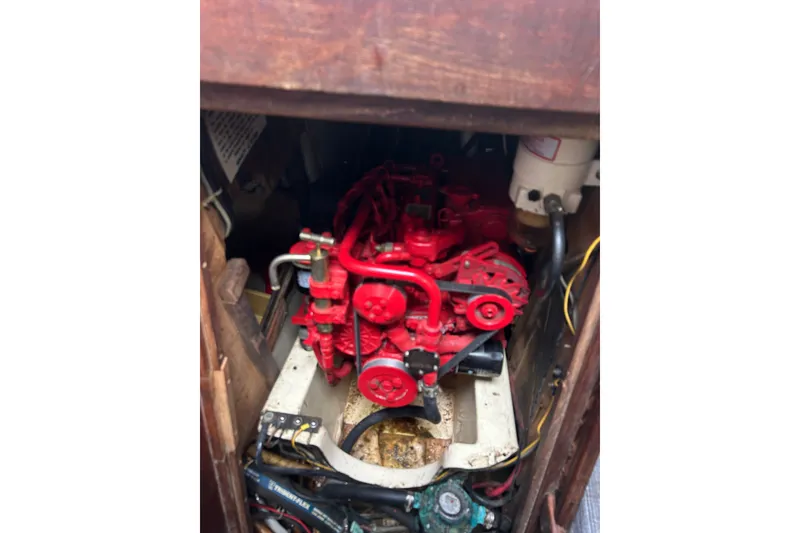 Slide: The Image of Red engine inside a 1979 Tartan 37 sailboat, showcasing mechanical components. - 41