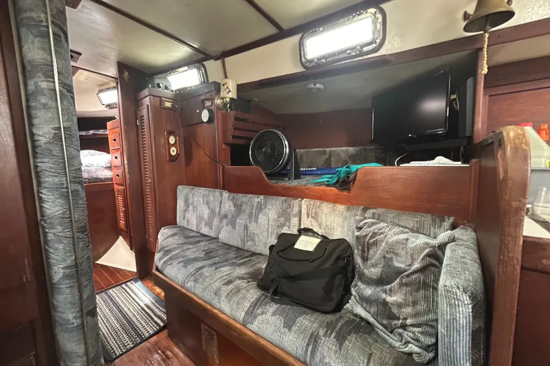 Slide: The Image of Interior of a 1979 Tartan 37 sailboat with cozy seating and wooden accents. - 27