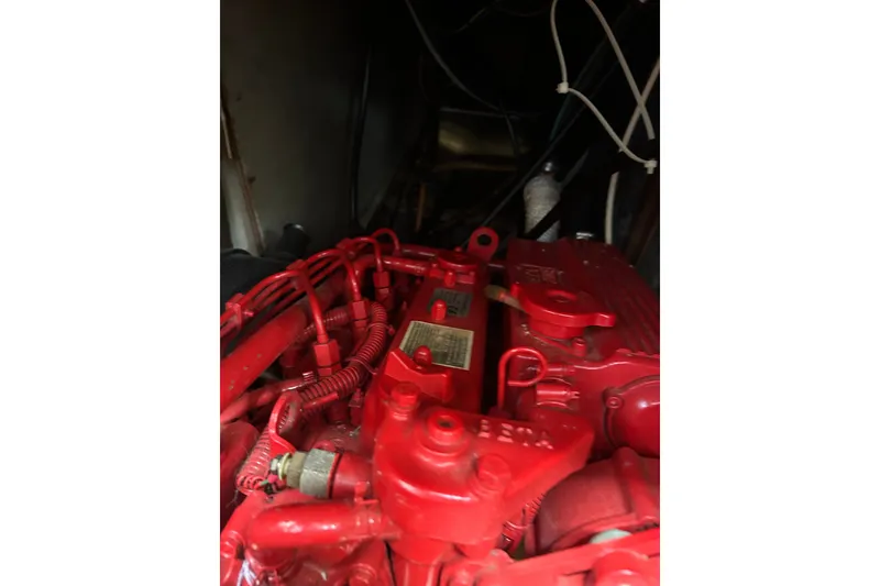 Slide: The Image of Red engine inside a 1979 Tartan 37 sailboat, showcasing intricate wiring and components. - 42